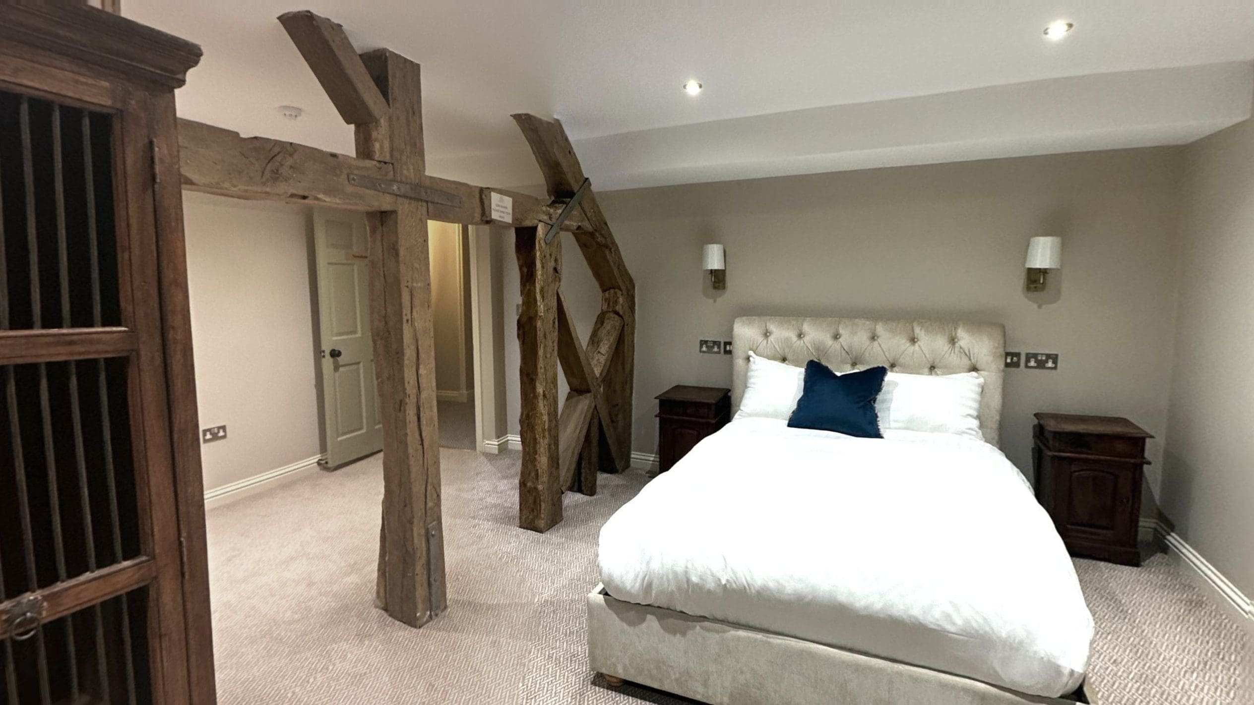 Newnham Suite bedroom with wooden beams at Owston Hall Hotel Doncaster