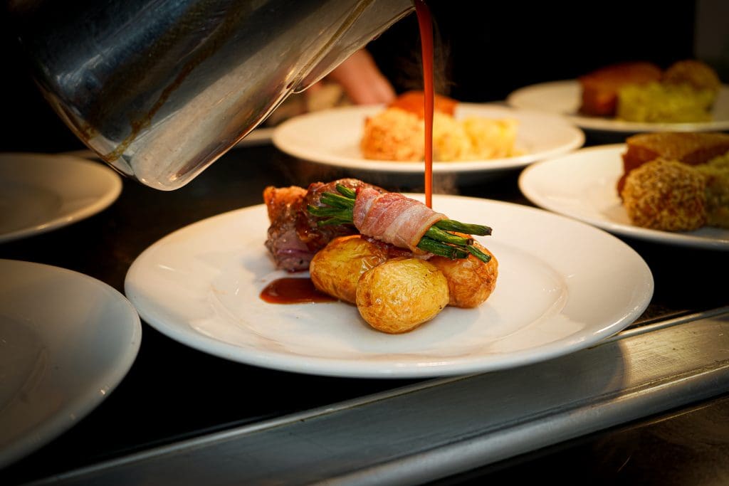 chef pouring gravy over a dish at Owston Hall Hotel Doncaster