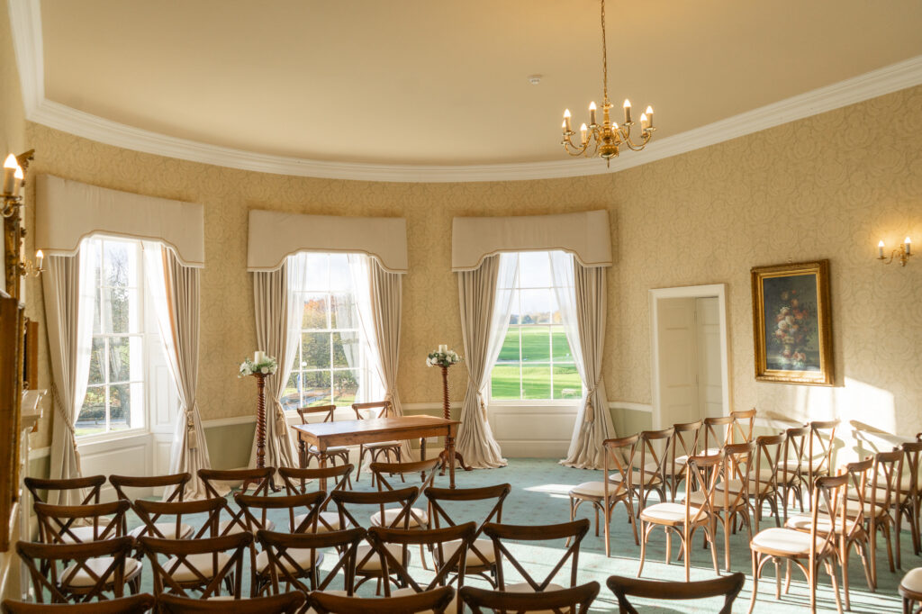 A wedding ceremony at Owston Hall Hotel Doncaster with wooden chairs